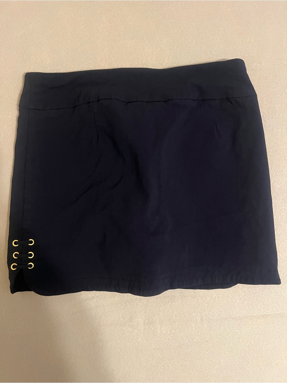 Attyre Navy Mini Skirt with Gold Eyelet Accents